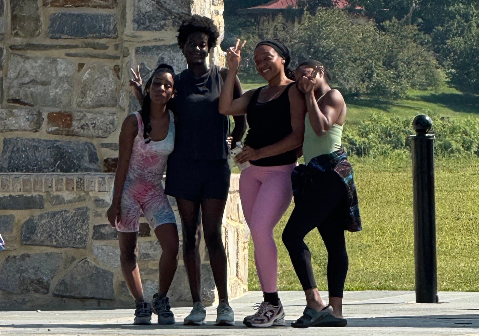 Four FitCamp members smiling together after class