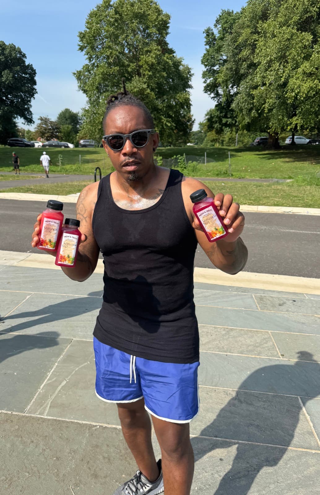 Client showing off three bottles of fresh-pressed juice